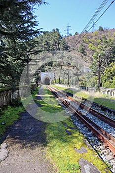 entrance arch in the old abandoned railway tunnel and passenger platform in Gagra, Abkhazia