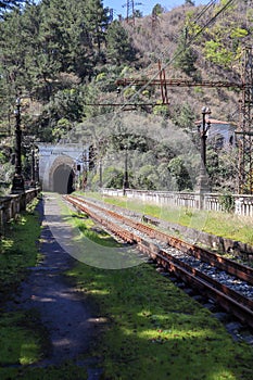 entrance arch in the old abandoned railway tunnel and passenger platform in Gagra, Abkhazia