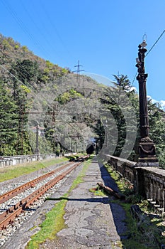 entrance arch in the old abandoned railway tunnel and passenger platform in Gagra, Abkhazia