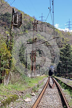 entrance arch in the old abandoned railway tunnel and passenger platform in Gagra, Abkhazia