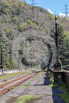 entrance arch in the old abandoned railway tunnel and passenger platform in Gagra, Abkhazia