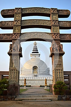 Entrance arch to the stupa Shanti with the stupa in the background in Delhi photo