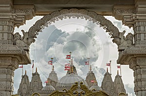 Entrance archway of the Neasden temple (BAPS Shri Swaminarayan Mandir) against a nice cloud sky background