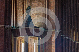 Entrance area of a historic industrial building with an owl made of copper in Berlin