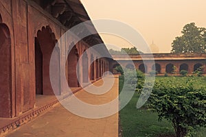 Entrance area to the Taj Mahal before sunrise in misty day