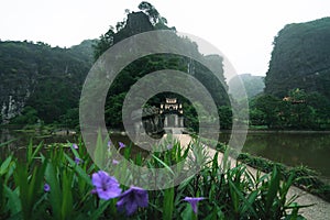 Entrance of Bich Dong Pagoda settled between green overgrown karst mountains, Ninh Binh, Vietnam