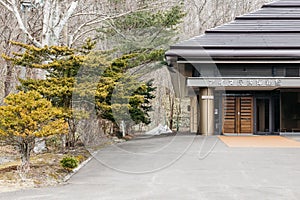 Entrance with big Bonsai trees near Shiraoi Ainu Village Museum in Hokkaido, Japan