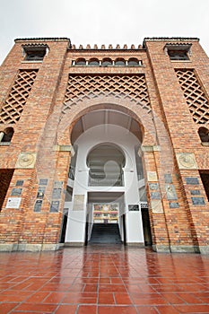 Entrance of bull fighting arena with reflections photo