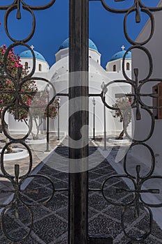 Entrance with closed gate of the church of Perissa. Santorini. G