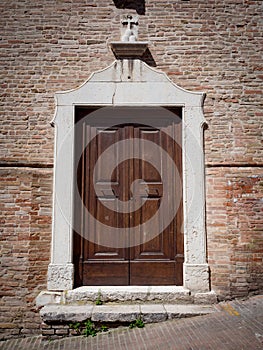 Entrance door of a church with white stone outline on red brick