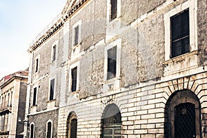 Entrance door, facade of old baroque building in Catania, traditional architecture of Sicily, Italy