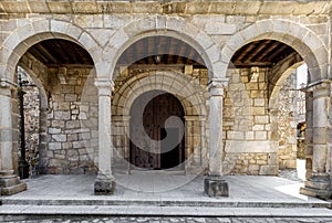 Entrance door and main facade of ancient church in San Martin del Castanar. Sierra de Bejar. Salamanca. Spain. photo