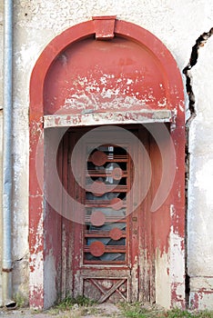 Entrance door to an old damaged building