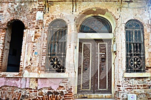 Entrance door and windows of a very old house abandoned in Buyukada, Istanbul