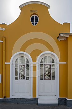 entrance doors of picturesque old mellow yellow building at historical town, Luderitz, Namibia