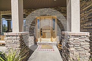 Entrance exterior of a house with stone veneer siding photo