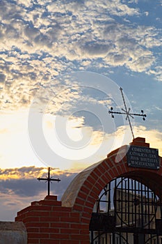 Entrance fronton of a catholic cemetery with crosses