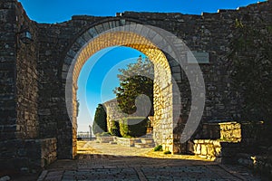 Entrance gate Arch of Lekursi Castle Kajala e Lekuresit. Saranda Albania during sunset