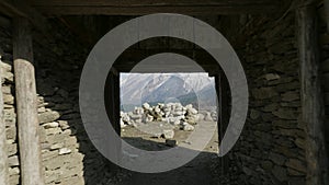 Entrance gate to nepalese village Sama Gaon among the mountains.