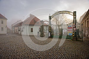 The entrance gate to the old brewery and malting plant on a foggy winter day. Znojmo, Czech Republic