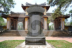 Entrance gate with wooden guards to the garden of Thien Mu Pagoda, Hue City, Vietnam