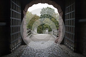 Entrance gateway to Fortress Marienberg with wooden and metal doors and bridge photo