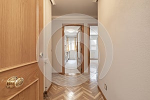 Entrance hall of a house with oak parquet flooring and matching wooden doors
