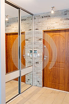 Entrance hall in modern apartment with mirror wardrobe