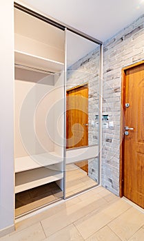 Entrance hall in modern apartment with mirror wardrobe