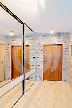 Entrance hall in modern apartment with mirror wardrobe