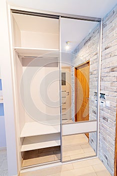 Entrance hall in modern apartment with mirror wardrobe