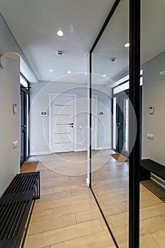 Entrance hall of a private dwelling house with mirror reflection