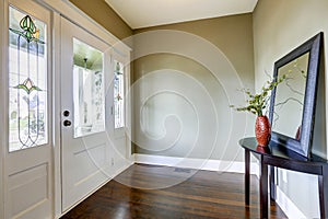 Entrance hallway with small table and mirror photo