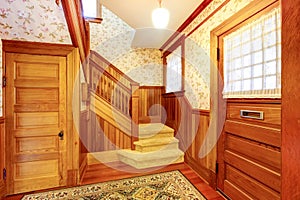 Entrance hallway with staircase and beige carpet covered steps