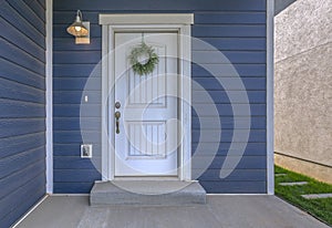 Entrance of a home with blue wall and white door