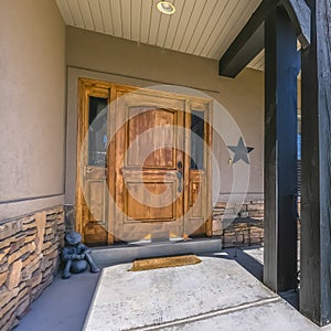 Entrance of home with brown door and sunny porch