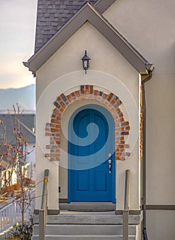 Entrance of home with stairs and arched blue door