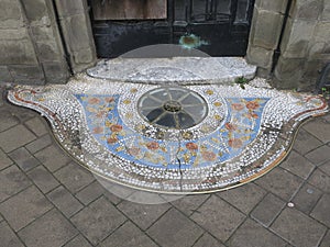 entrance of a house with a decorated mosaic floor