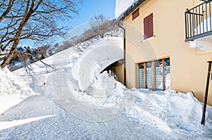 Entrance of the house hidden under the snow.