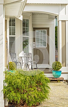 Entrance of a luxury house with a patio. Home exterior with patio area with nice landscaping desing around