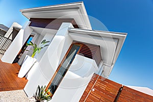 Entrance of a luxury house with white walls and blue sky on a sunny day