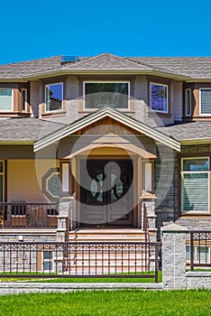 Entrance of luxury residential house with metal fence in front