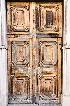 Entrance of a medieval cathedral with wooden door.