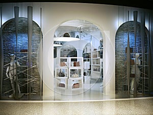Entrance into a modern store selling handbags.