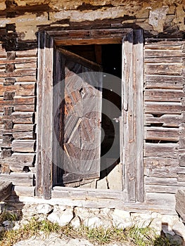 Entrance of an old abandoned traditional rustic wood house. Fundata Romania