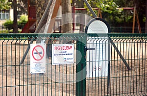 Entrance of an outdoor children`s playground with warning signs in Hungary
