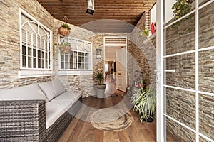 Entrance porch of a multi-story single-family house with brick facades of different models, white windows and doors and many