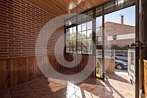 Entrance porch to a single-family house covered in wood