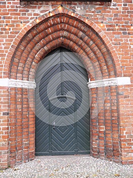 Entrance portal and wooden door on a Gothic church in Lübeck