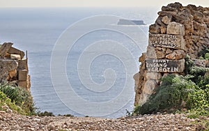 Entrance with private and no entrance Eingang Verboten lettering on Dingli Cliffs with the Maltese Island Filfla in the